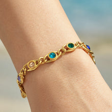 Blue and green zircon bracelet worn on wrist