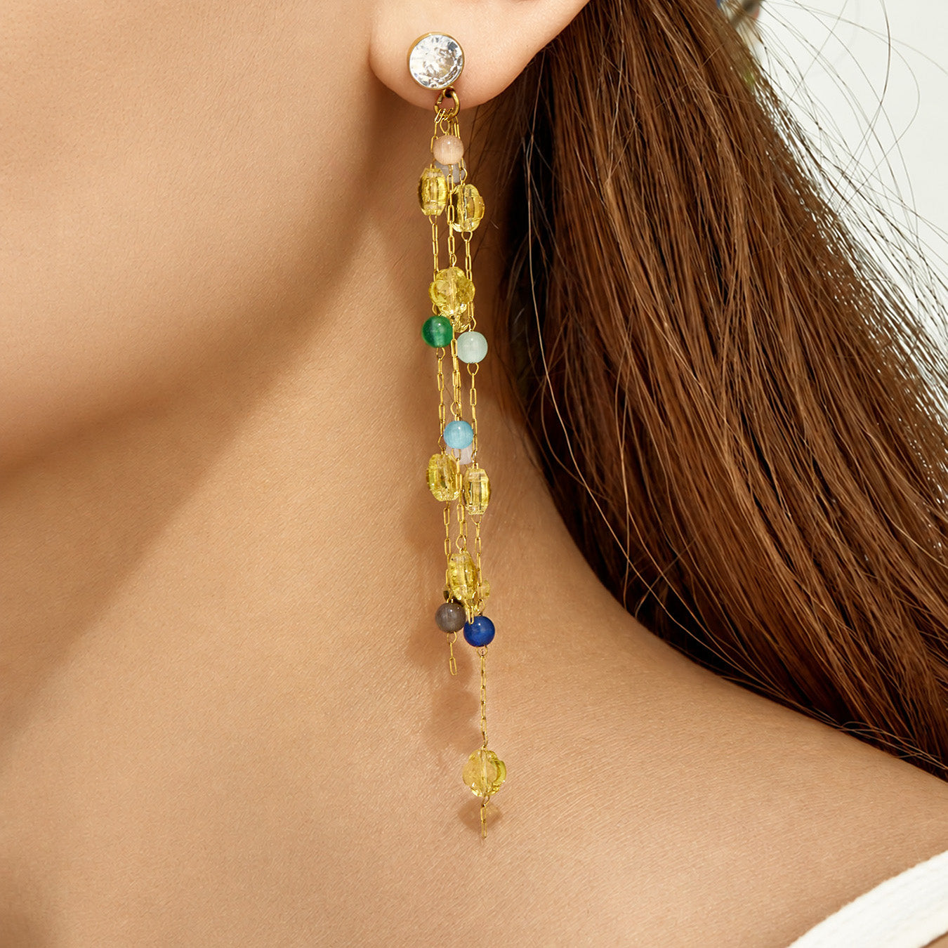 Blue natural stone drop earrings worn with elegant long dangle design