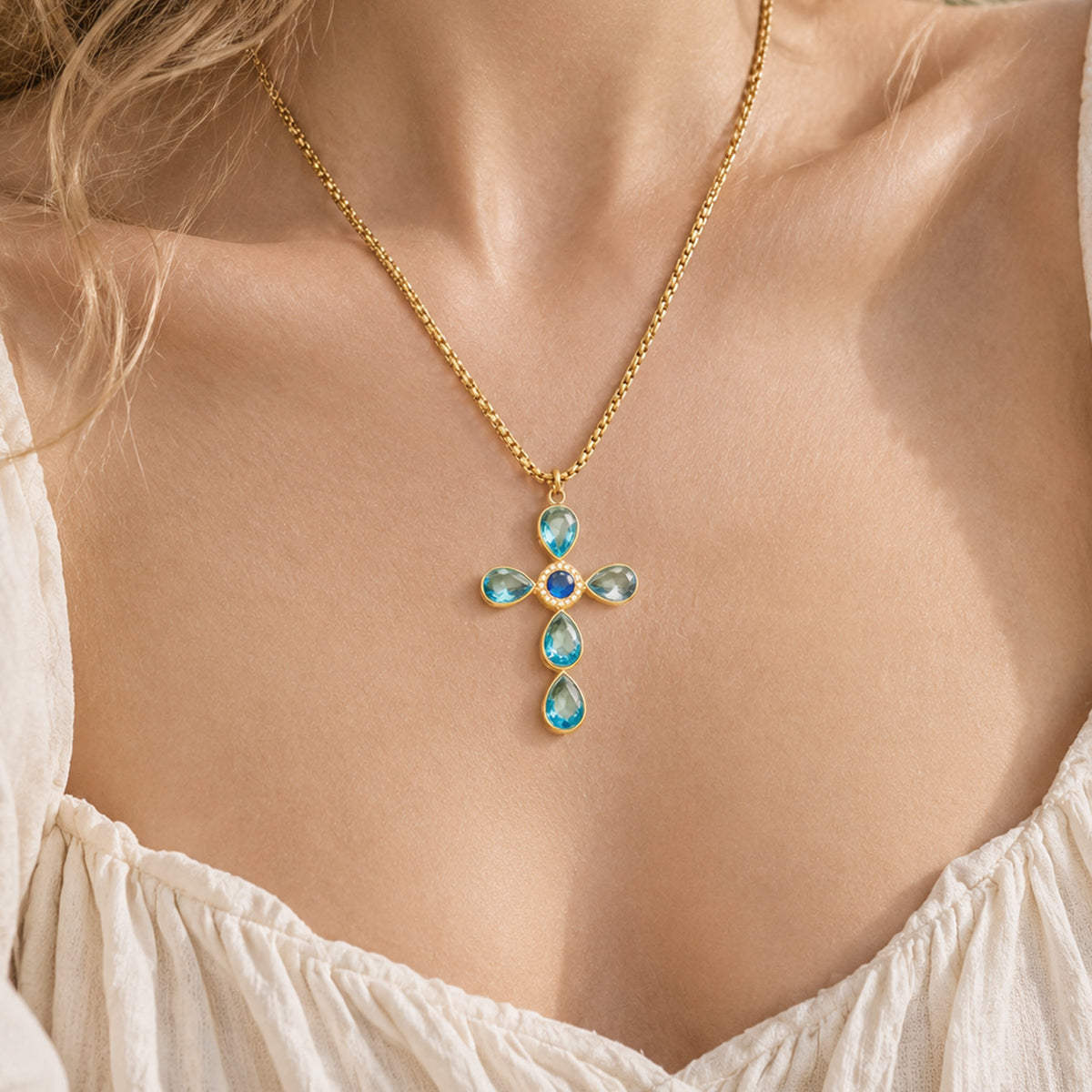 Blue stone cross pendant necklace worn on model