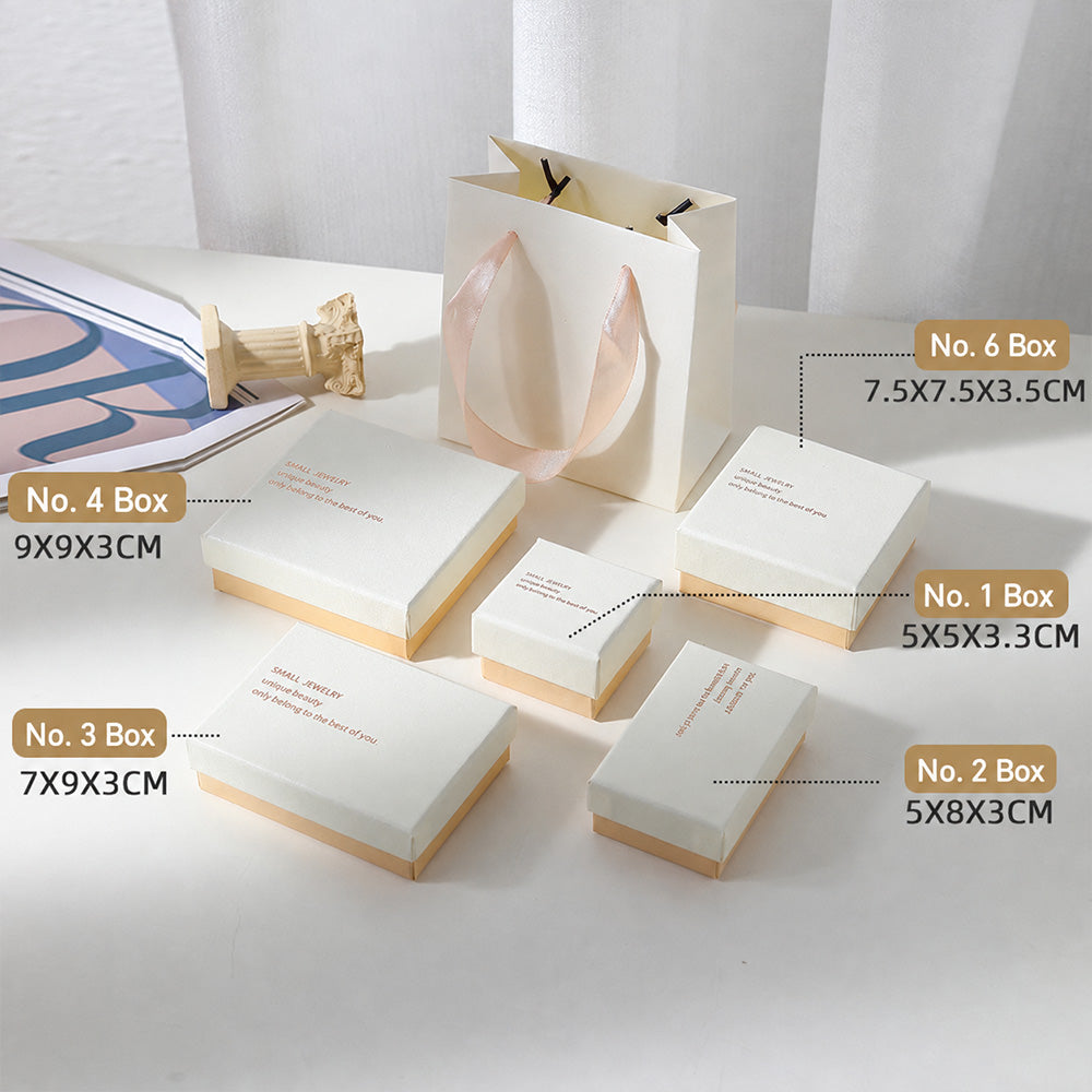 Boutique display of white and pink jewelry boxes for rings earrings necklaces and small jewelry pieces