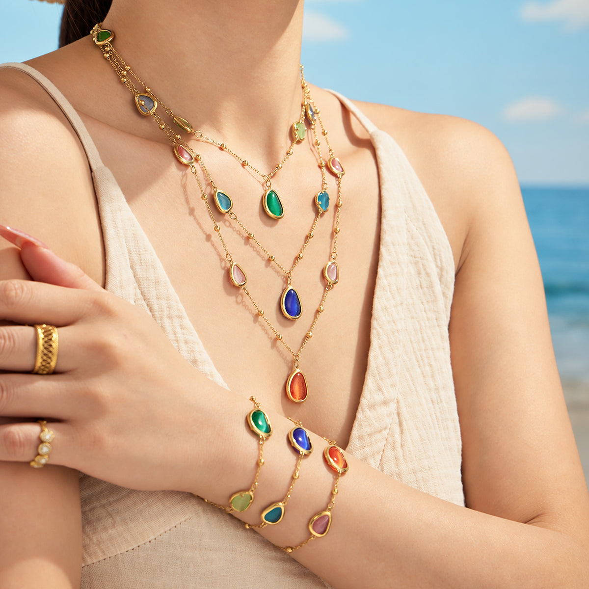 Gold-tone cat eye necklace and coordinating bracelet styled together on model