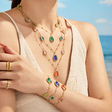 Gold-tone cat eye necklace and coordinating bracelet styled together on model