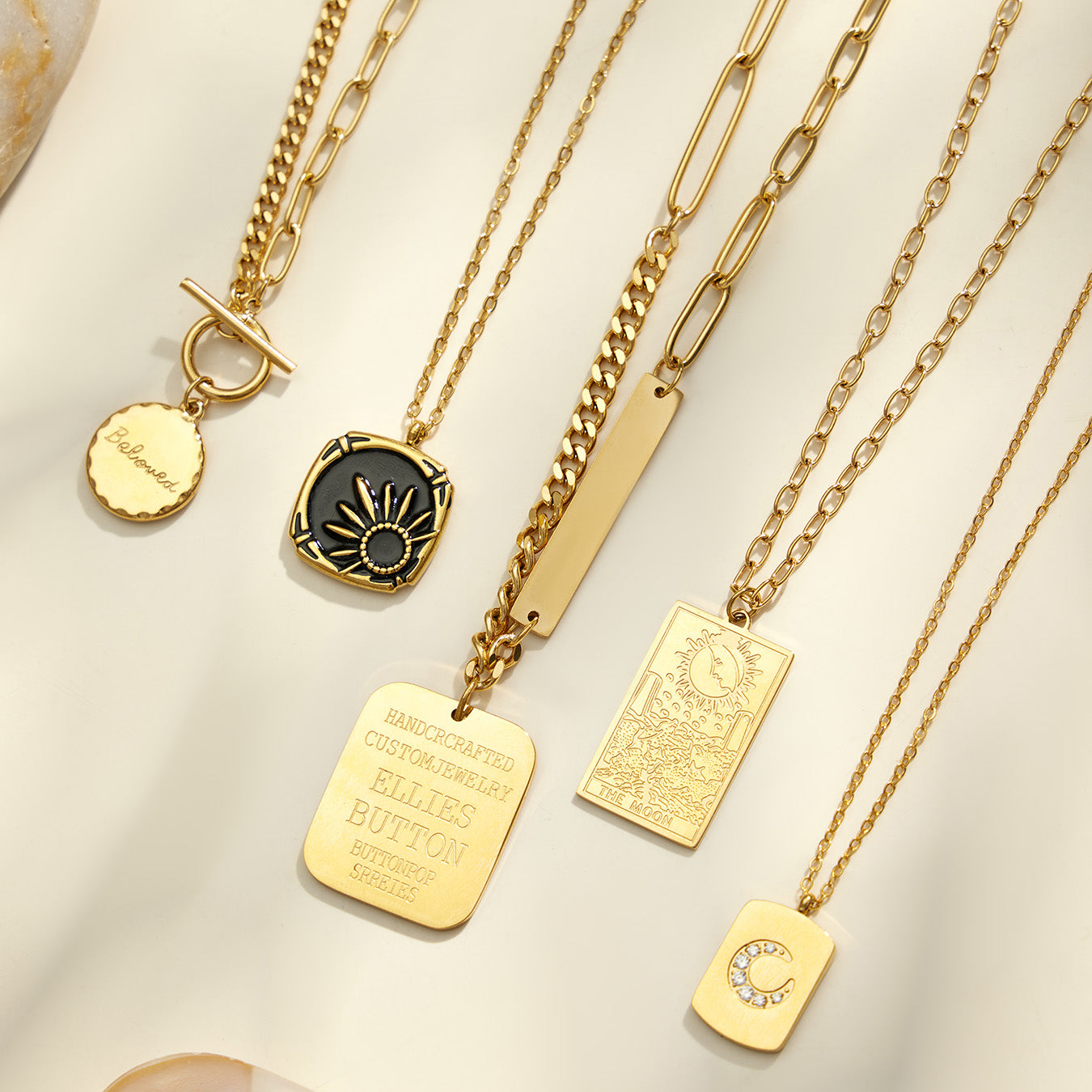 Close-up assortment of celestial, medallion and geometric pendant necklaces