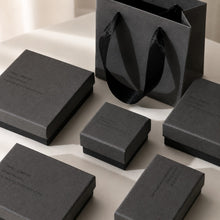 Charcoal gray jewelry boxes with matching black ribbon gift bag for retail packaging