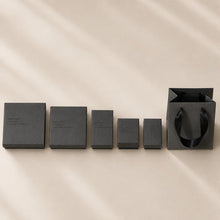 Charcoal jewelry boxes arranged by size for rings earrings bracelets necklaces and jewelry sets