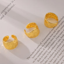 Chunky gold hammered open ring flat lay showing wide sculptural band
