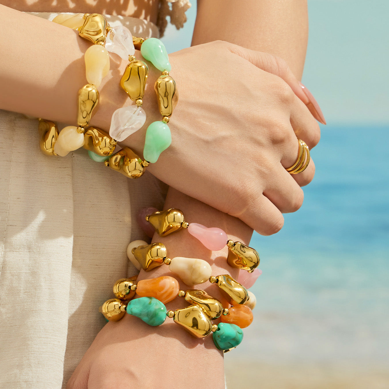 Model wearing stacked chunky resin bracelets in multiple colors for a bold statement jewelry look