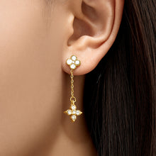Model wearing clear cubic zirconia four-leaf clover drop earrings