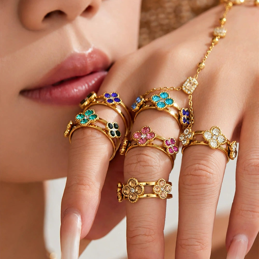 Model wearing colorful clover flower zircon stack rings in 18K PVD gold stainless steel for boutique ring displays