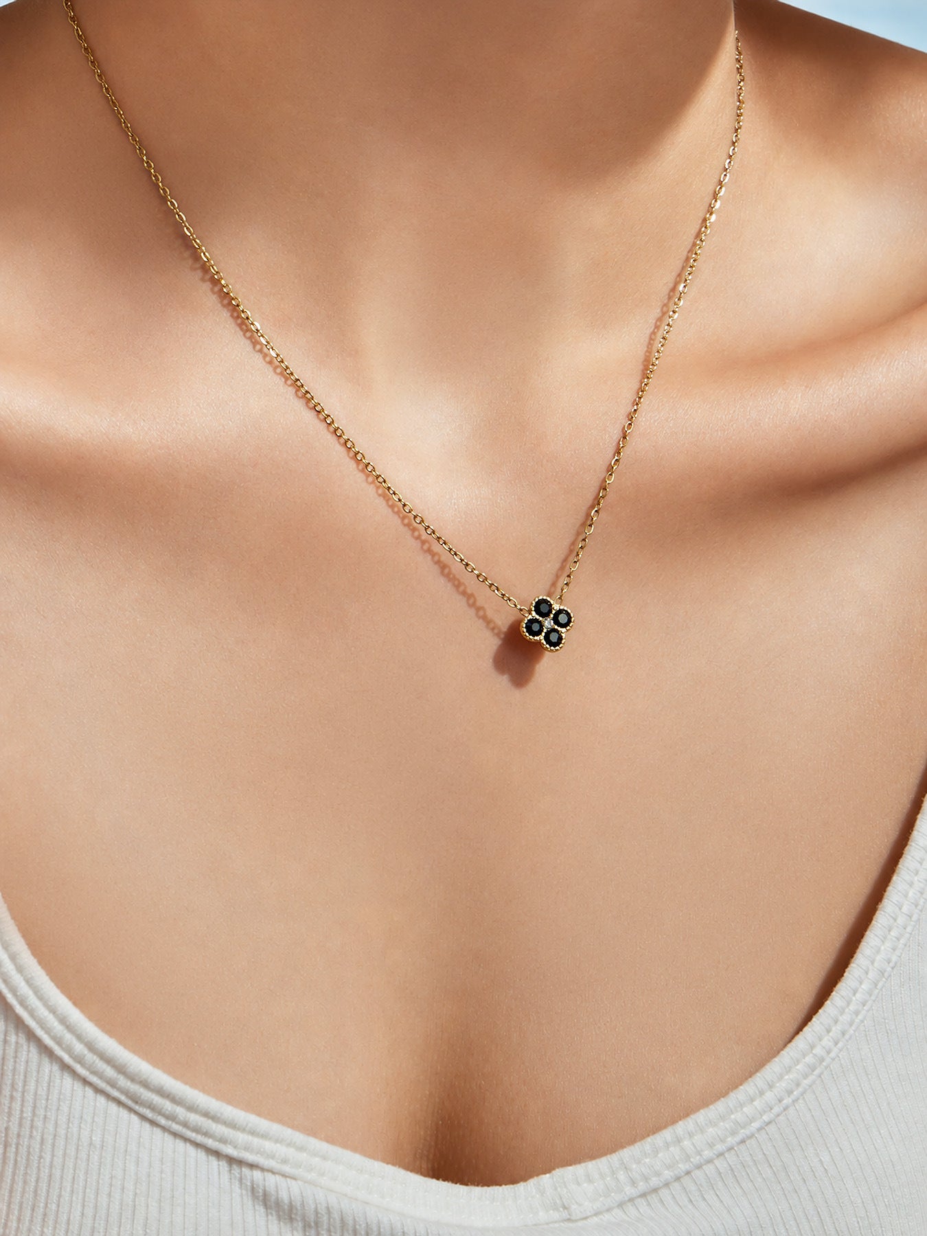 Neck close-up of colorful clover zircon pendant necklace in 316L stainless steel jewelry