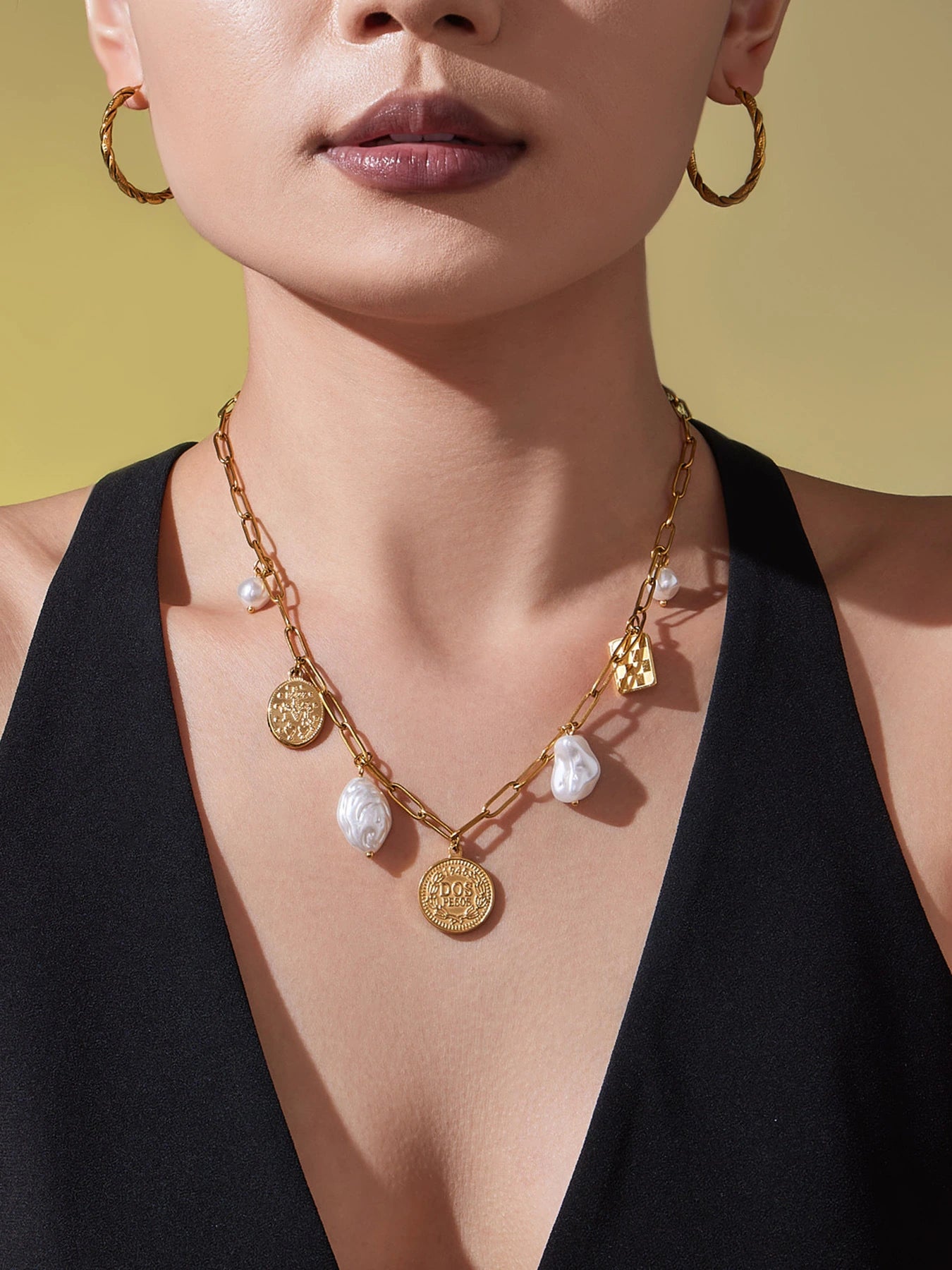 Gold paperclip charm necklace with coin, checkerboard and irregular pearl-look pendants