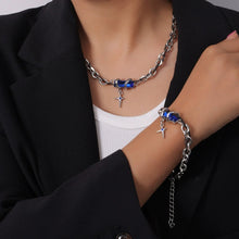 Model wearing layered stainless steel cross necklaces with color zircon accents for street-style and trend jewelry displays