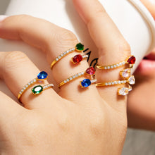 Colorful adjustable stainless steel open rings with white cubic zirconia accents on hand
