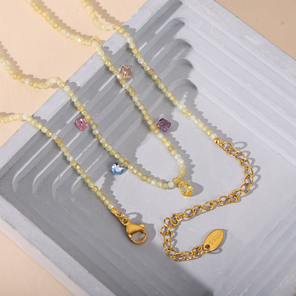 Colorful natural stone beaded necklaces with gold stainless steel chains arranged in a flat lay