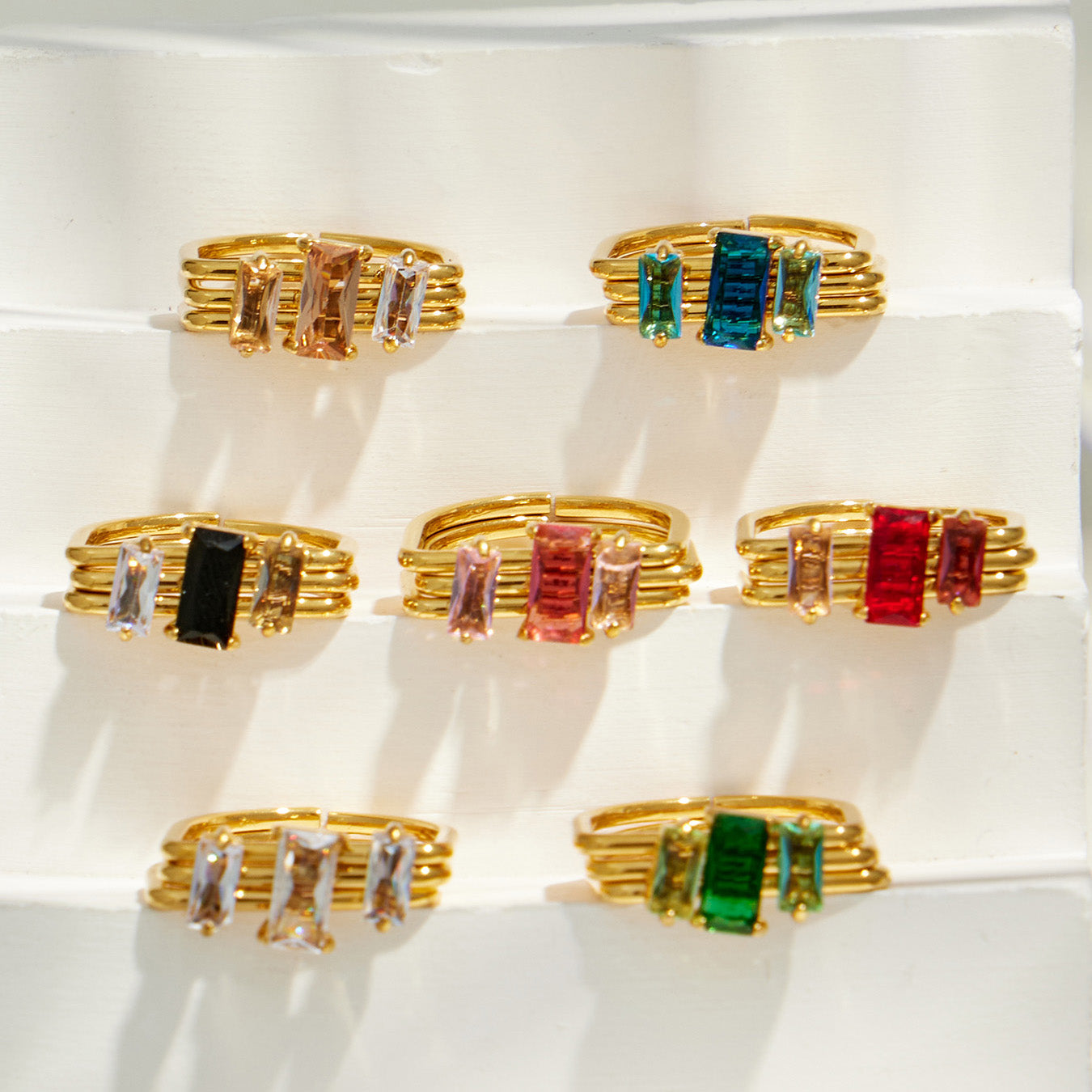 Assorted colorful cubic zirconia statement rings arranged in a boutique jewelry display