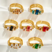 Colorful emerald-cut CZ multi-band rings displayed together in white pink black green blue and red options