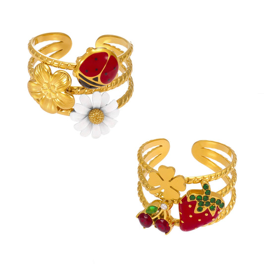 Gold colorful enamel statement rings featuring daisy, ladybug and strawberry designs with wide openwork bands