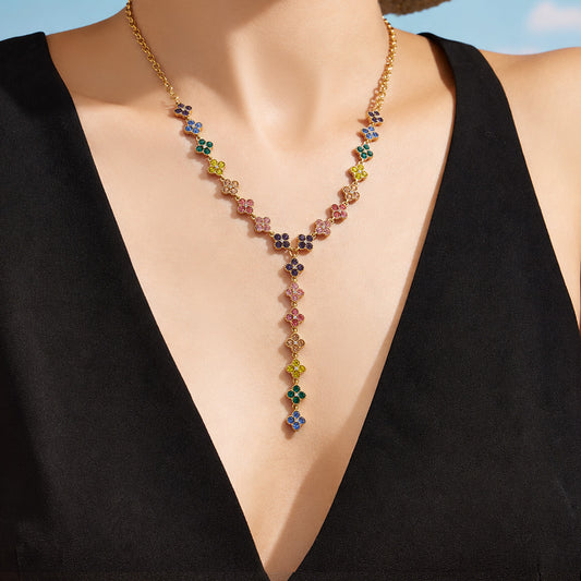Model wearing a colorful floral Y necklace with a black V-neck outfit