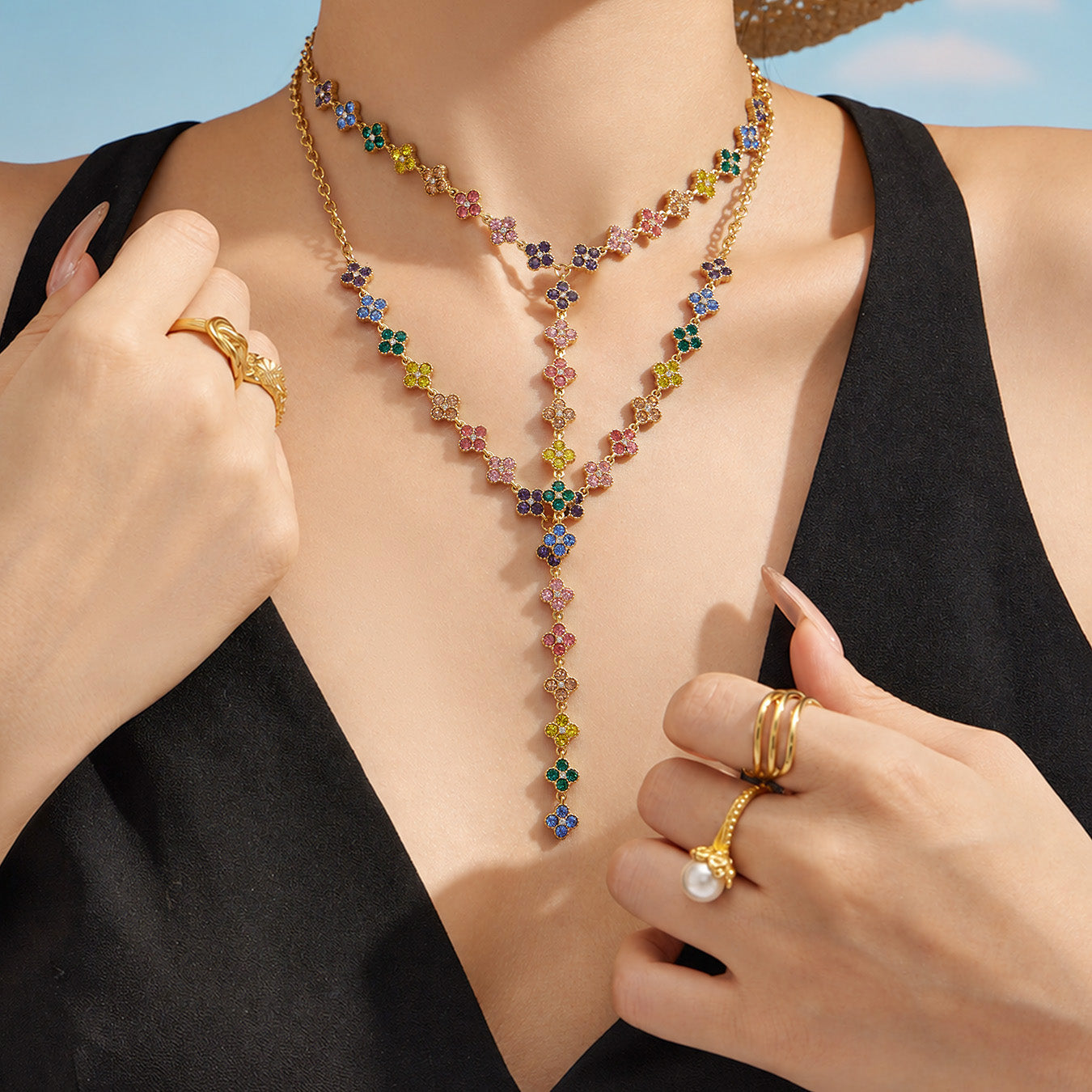 Model touching a colorful flower lariat necklace to show the long drop design