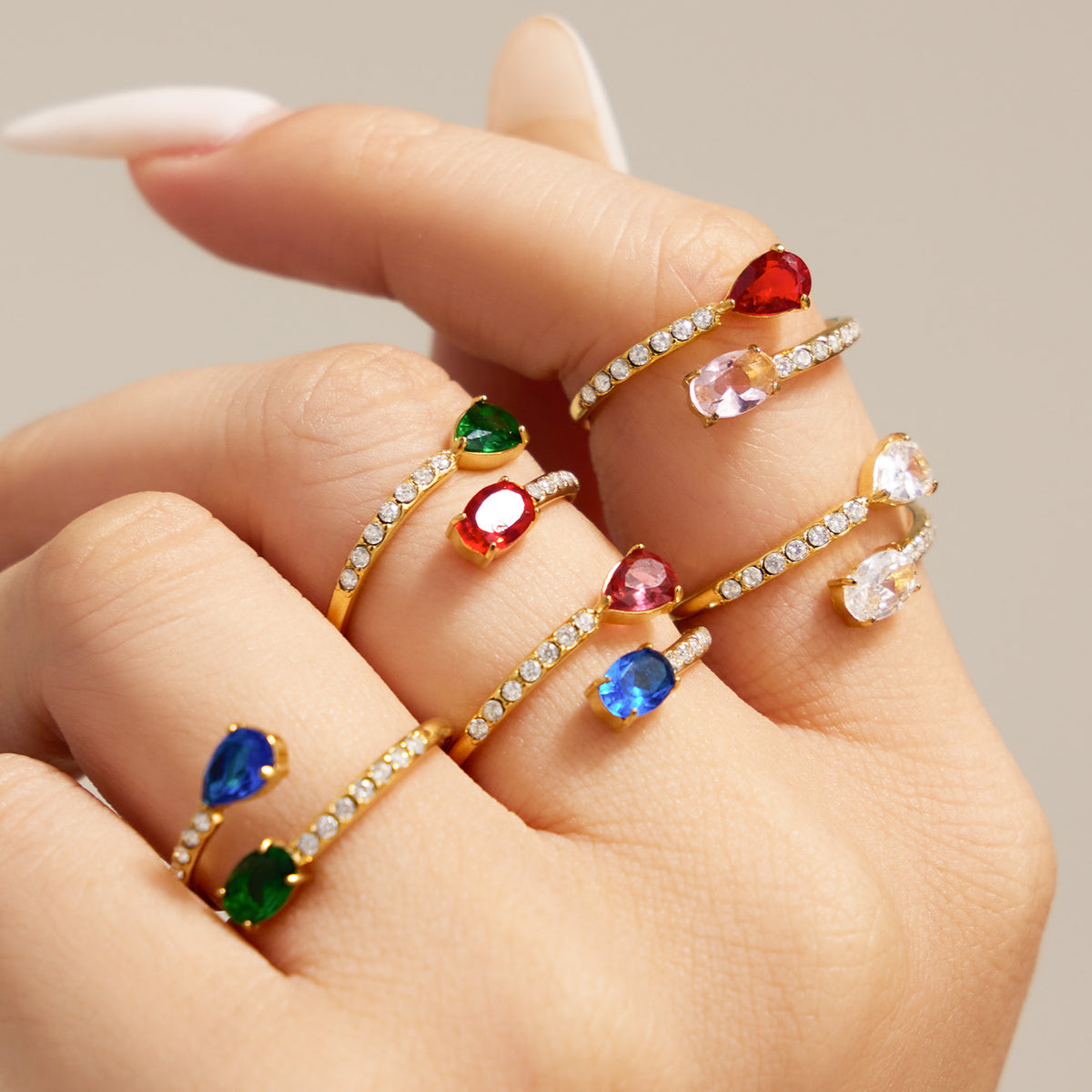 Colorful stainless steel adjustable rings with white CZ and colored glass styled on hand
