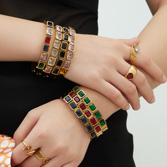 Woman wearing 18K gold plated stainless steel colorful square glass stone bangles on wrist