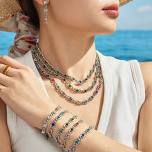 Colorful zircon necklaces and bracelets layered together