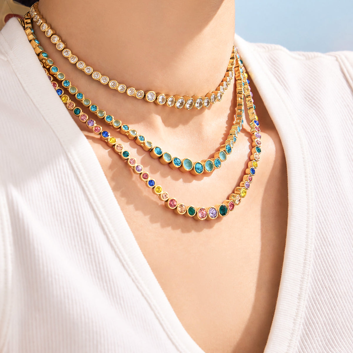 Colorful zircon necklace layered on neckline