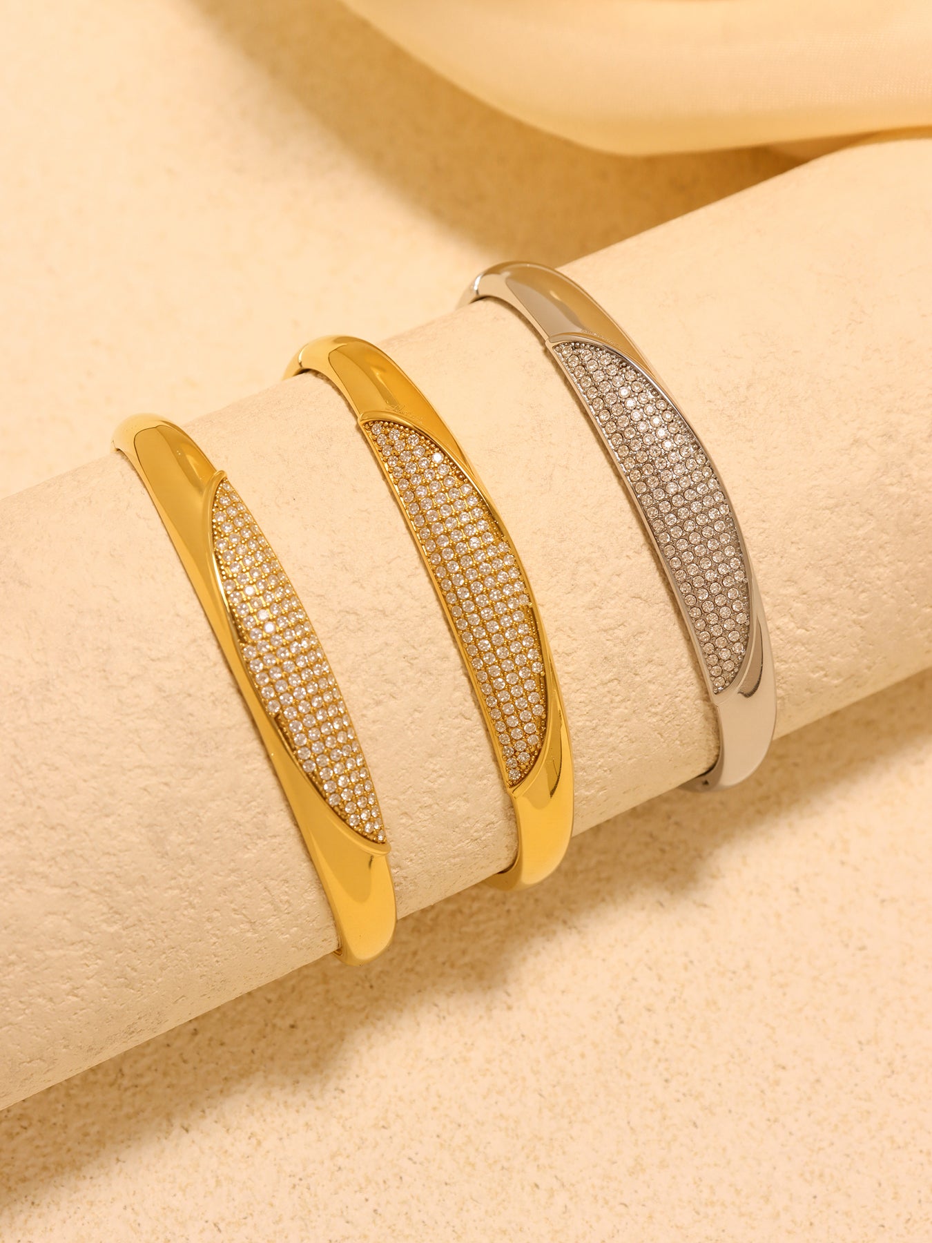 crescent zircon paved bangle scene styling - multi-color zircon bangles displayed on fabric