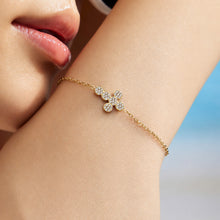 Close-up of a clear zircon cross bracelet worn on the wrist