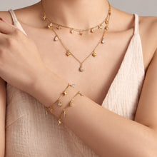 Dainty cross and teardrop zircon necklace and bracelet styled on model