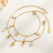 Gold-tone cross and heart charm bracelets with teardrop zircon details