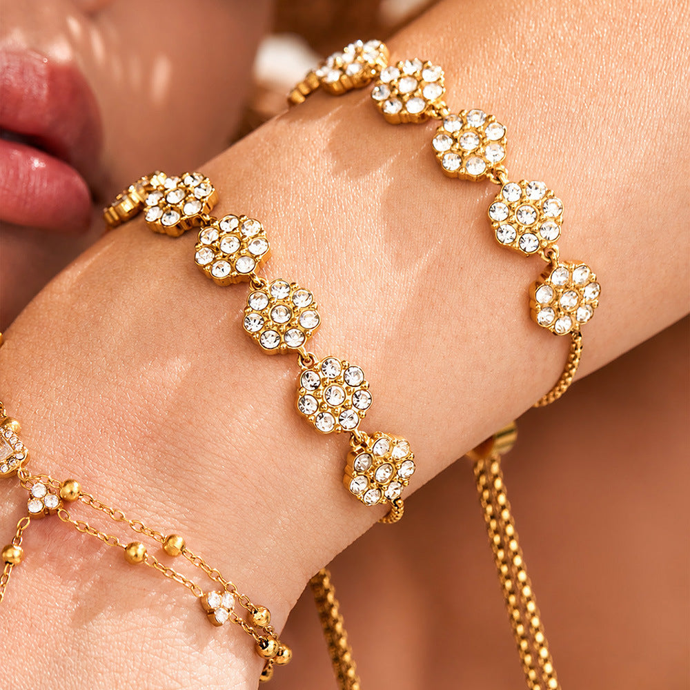 Model wearing CZ flower bracelet with necklace and rings in resort-inspired styling for boutique and vacation jewelry displays