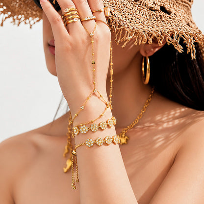 Model wearing CZ flower bracelet with necklace and rings in resort-inspired styling for boutique and vacation jewelry displays