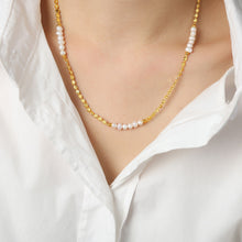 Gold plated pearl splice necklace styled in soft sunlight with freshwater pearl details for summer jewelry collections