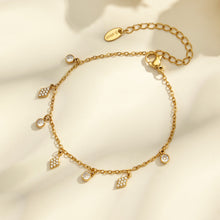 Flatlay of square, diamond and flower zircon charm bracelets with adjustable gold tone chain