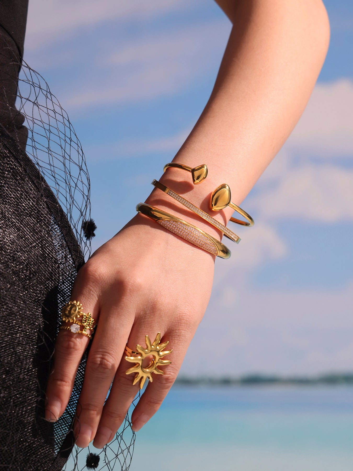 double heart open bangle model lifestyle photo - gold bangle styling with beach background