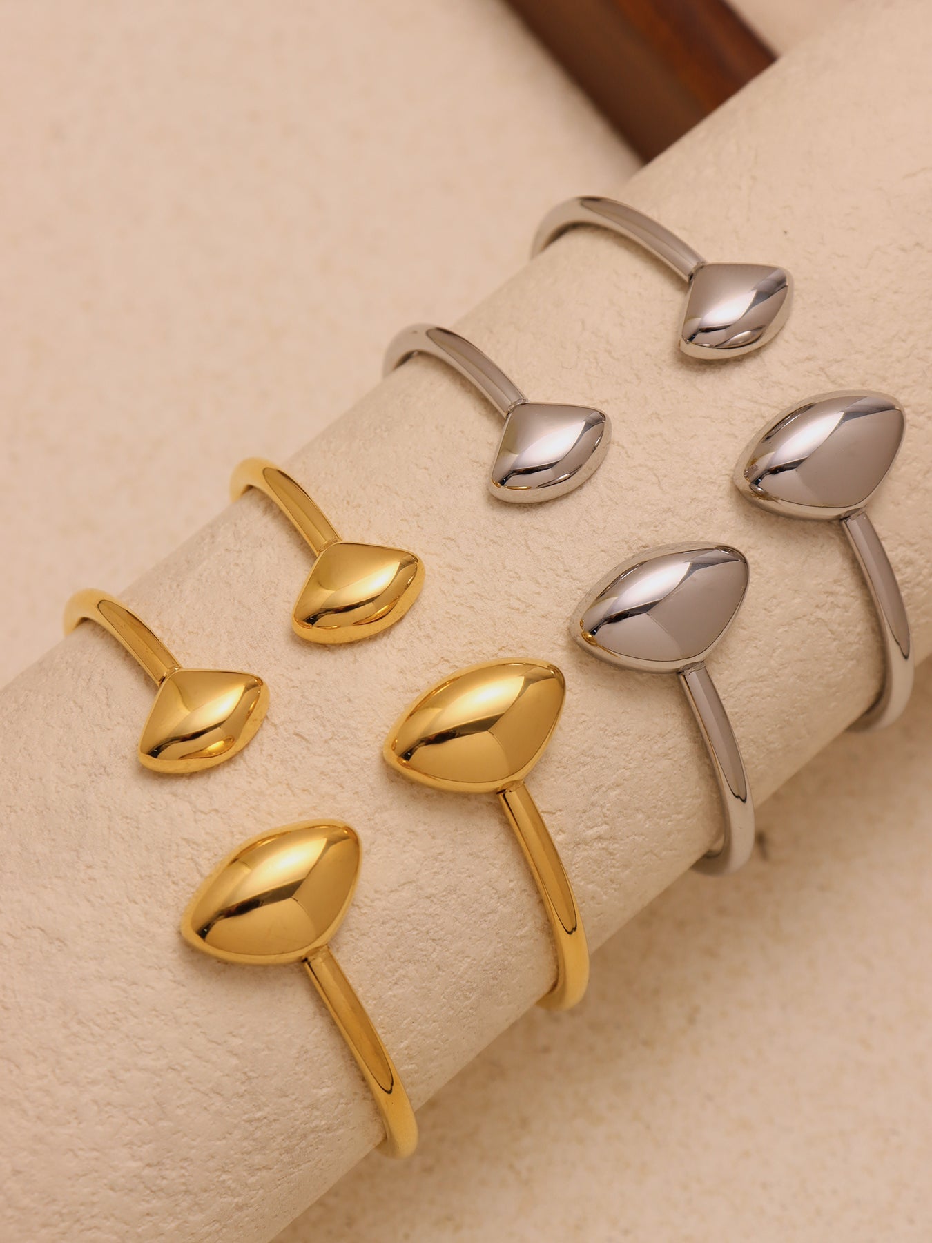 double heart open bangle scene styling - stacked gold bangles on wrist with outfit