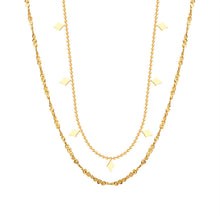 Double-layer geometric charm necklace in gold-tone stainless steel displayed on a white background