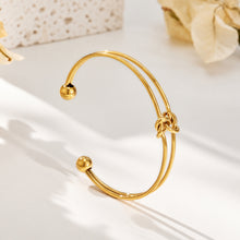 Stainless steel double wire open bangle with central knot detail