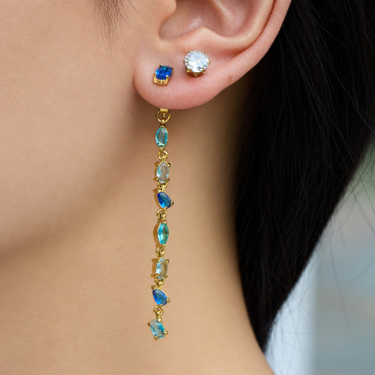 Close-up of green zircon earring design