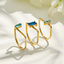 Side profile display of three emerald-cut cubic zirconia multi-band statement rings