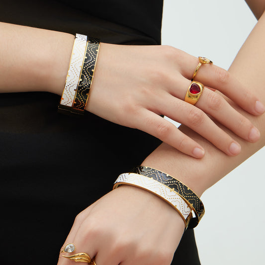 Woman wearing 18K real gold plated stainless steel enamel glaze oil-drip bangle, color-block intricate pattern design