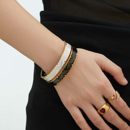 Close-up of 18K real gold plated stainless steel enamel glaze oil-drip bangle on wrist, luxury color-block pattern