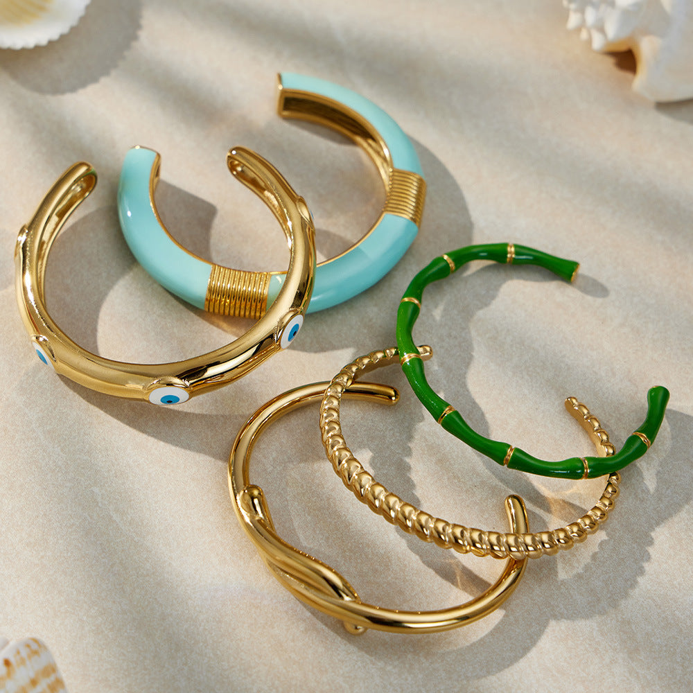 enamel stainless steel bangle set, displayed on textured surface