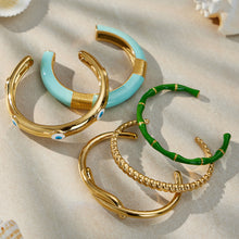 enamel stainless steel bangle set, displayed on textured surface
