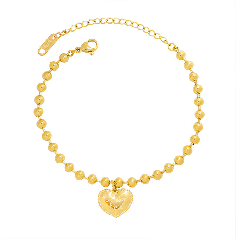 Gold engraved heart charm bracelet with polished beaded chain and adjustable extender