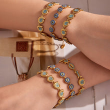 Evil eye blue zircon bracelet worn on wrist with 18K PVD gold finish and coastal jewelry styling