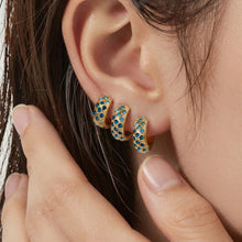 Three gold-tone blue CZ lattice hoop earrings shown at different sizes on an ear.