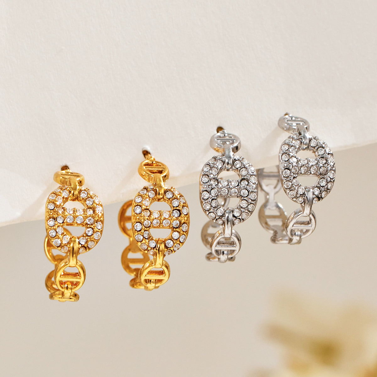 Gold and silver chain link hoop earrings displayed together with pavé zircon details for a mixed-metal assortment