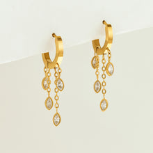 Gold chain charm hoop earrings displayed on a neutral background with marquise zircon drops
